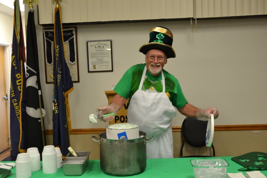 Cliff Hinkley shows off a scoop of Marvel Chocolate Chip Mint ice cream which fit the St. Patrick's Day menu perfectly with its green tint.