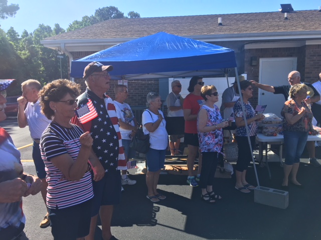 Participants paying respect to the flag as the National Anthem begins at the VFW Calabash Post #7288 Independence Day Celebration begins, July 4th, 2018.